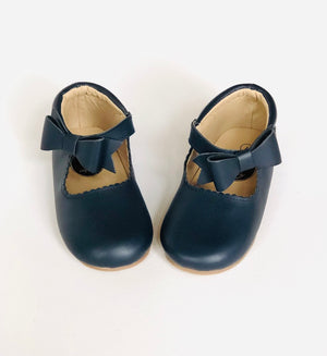 Classic navy blue leather baby Mary Jane shoes with scalloped trim, strap, and decorative bow, displayed on white background.