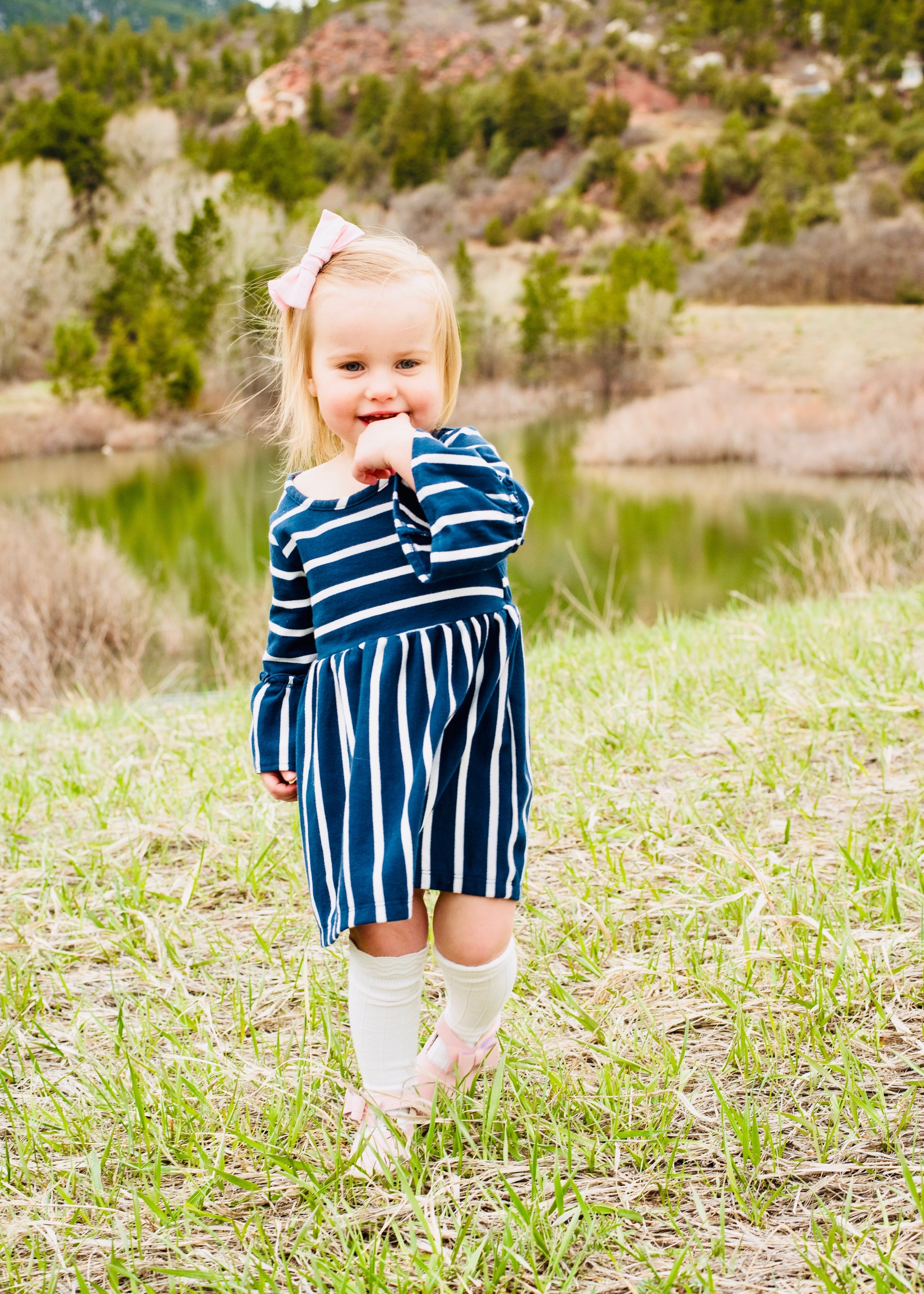 Child wearing white cable knit knee-high socks – perfect for everyday or special occasions